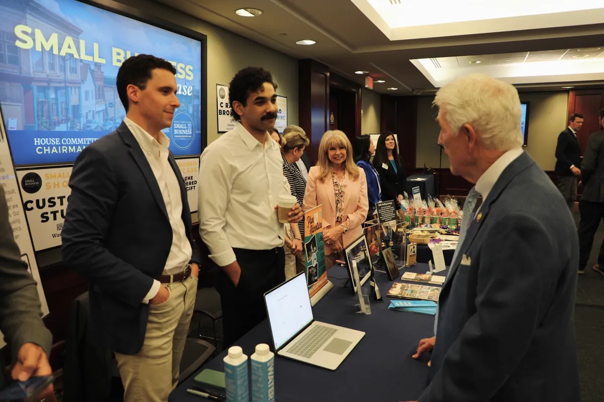 The team talking with visitors at the conference booth