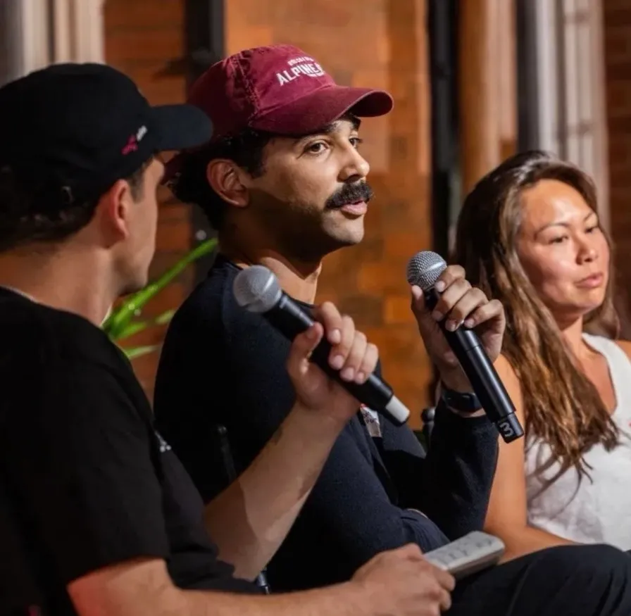 Devin speaking with a microphone on stage